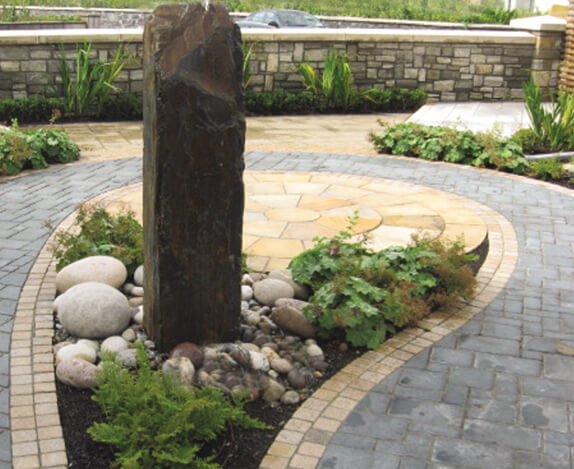 water feature with ferns and paving